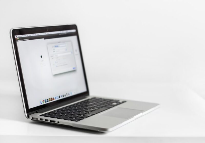 Laptop open to a web browser at a workspace, illustrating AI-assisted and agentic browsing.