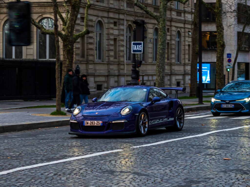 Modern car traveling through a city street