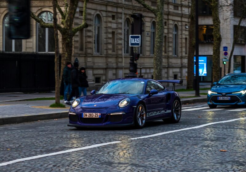 Illustrative photo of a modern car traveling along a European city street