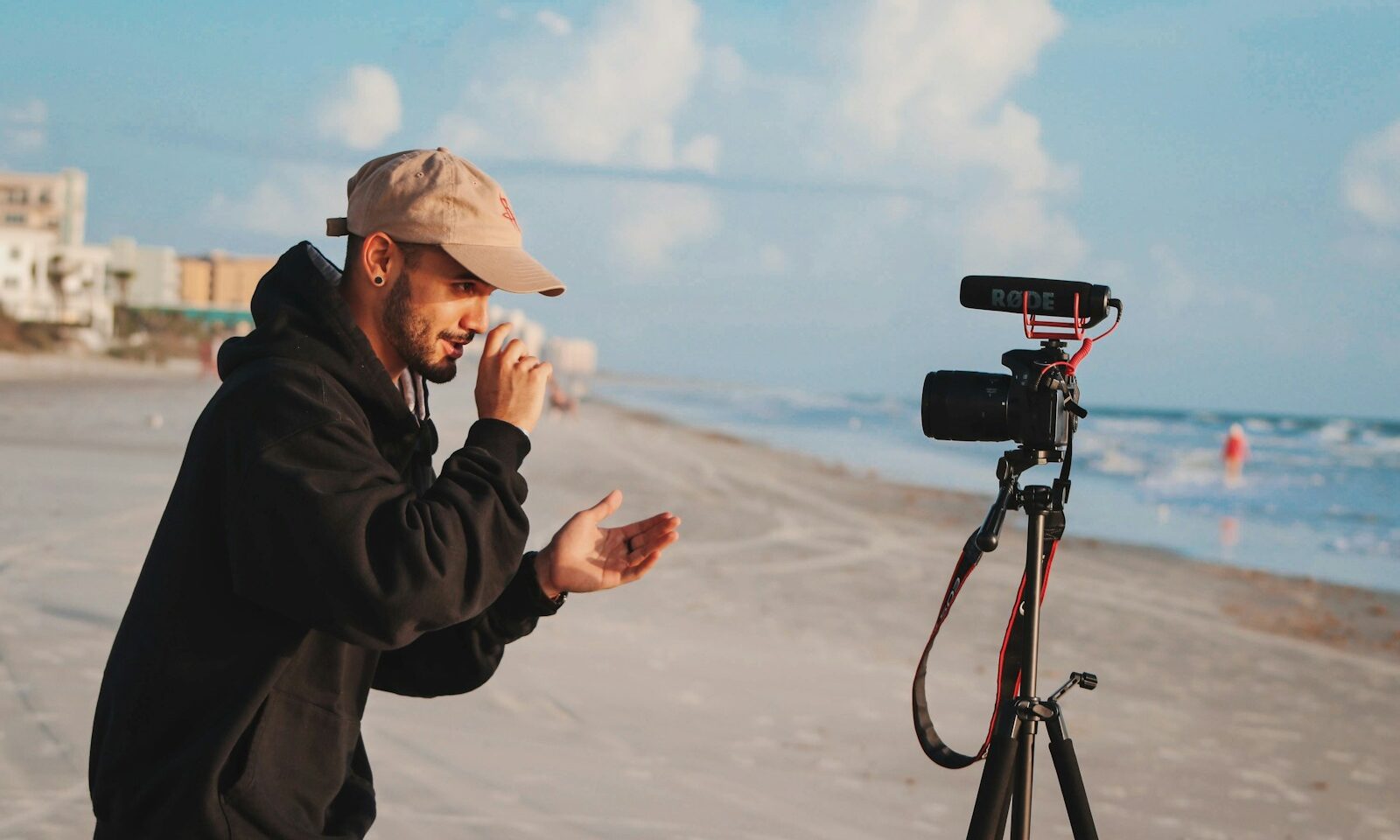 Content creator holding a camera outdoors