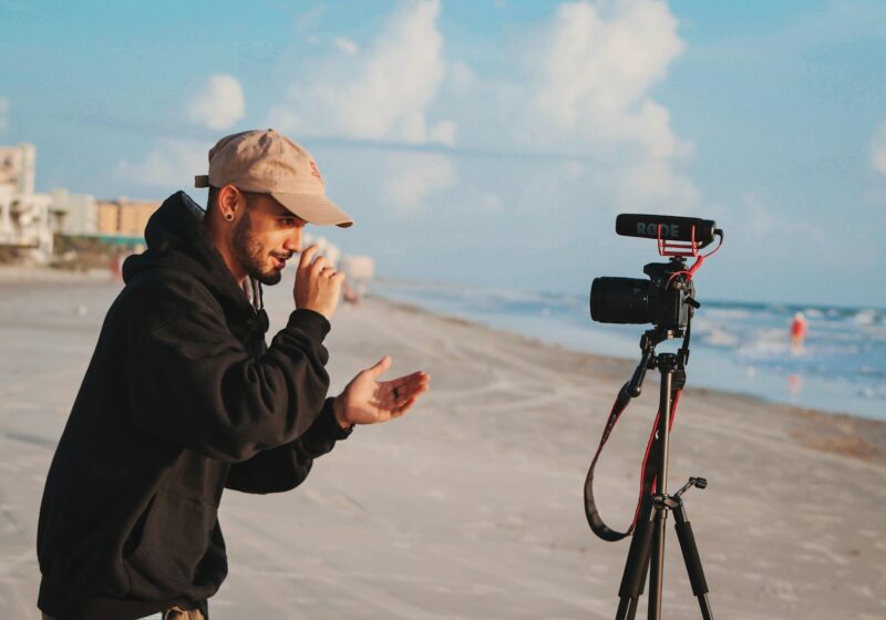 Content creator holding a camera outdoors