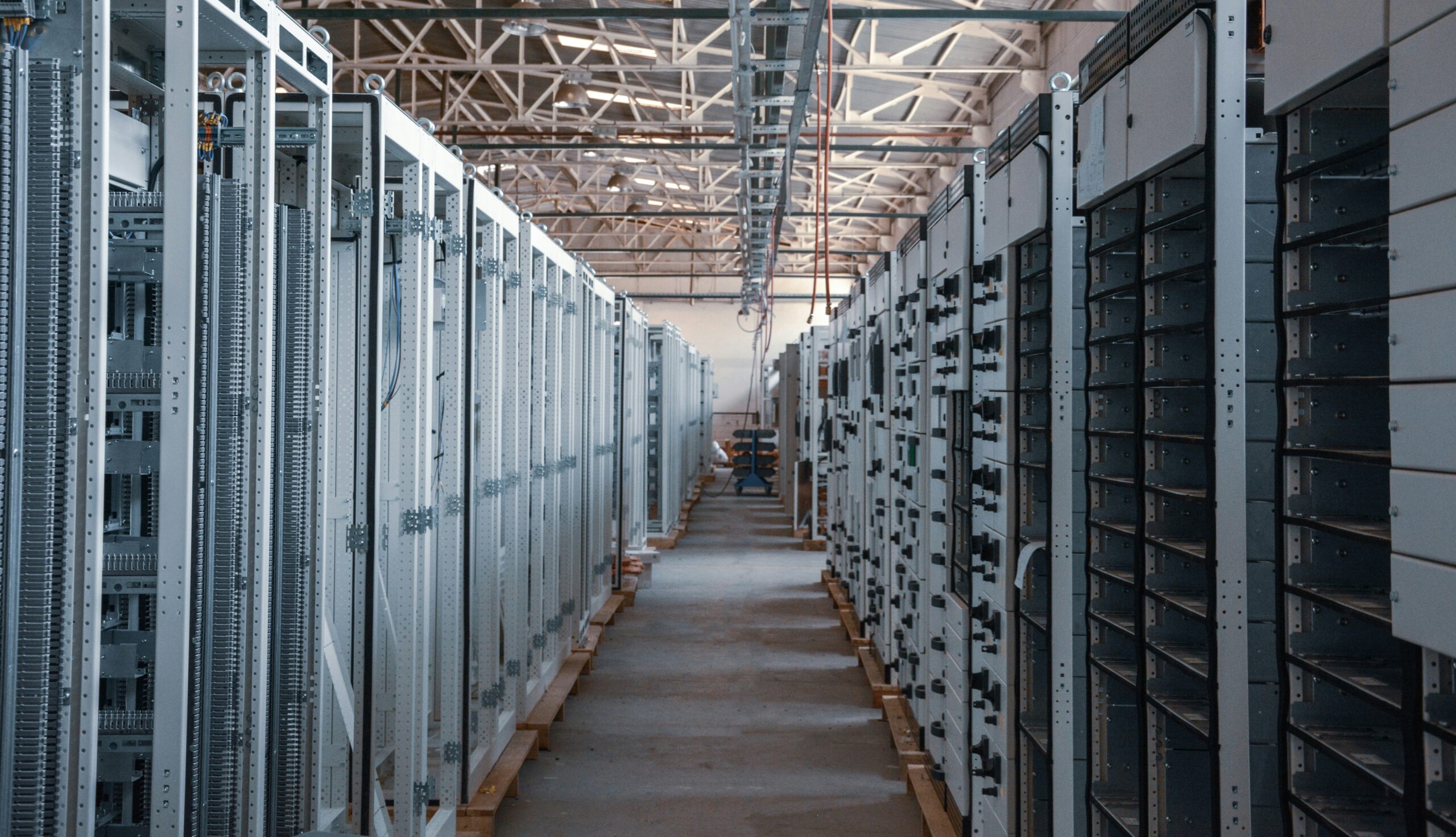 Rows of electrical and computing cabinets in a data center facility