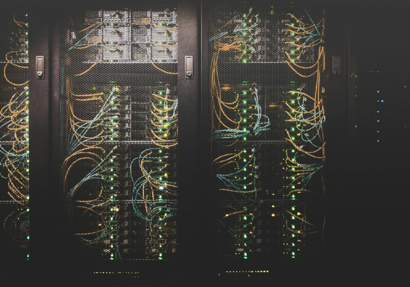 Rows of network cables connected inside a data center
