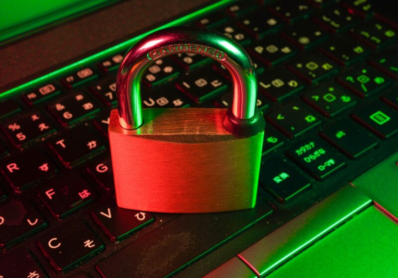 Glowing cybersecurity graphic on a laptop screen, illustrating AI content provenance and watermarking