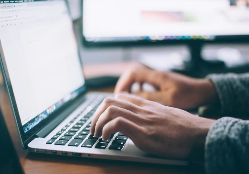 Person using a laptop, illustrating email privacy controls
