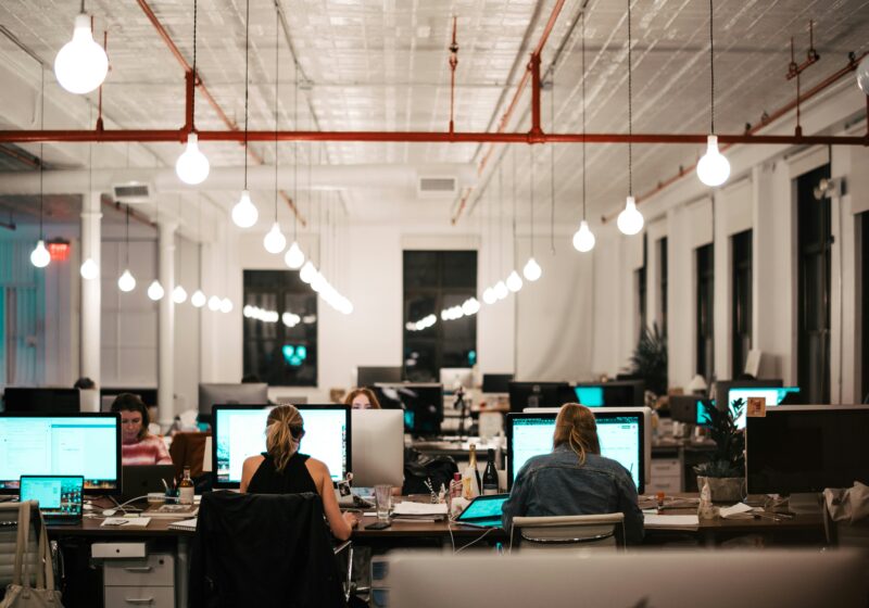 Illustrative photo of a technology consulting team working at computers in an office