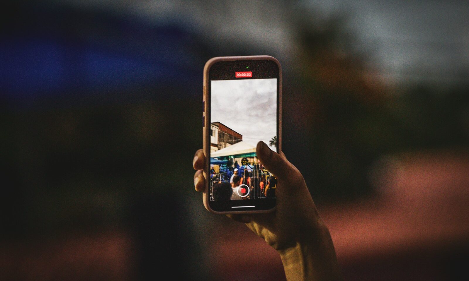 Person taking a picture with a smartphone, illustrating photo sharing