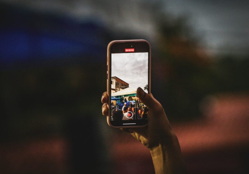 Person taking a picture with a smartphone, illustrating photo sharing