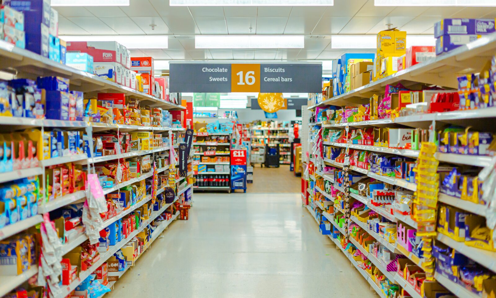 Shelves stocked with packaged goods in a retail store aisle