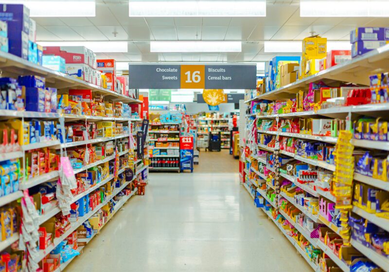 Shelves stocked with packaged goods in a retail store aisle