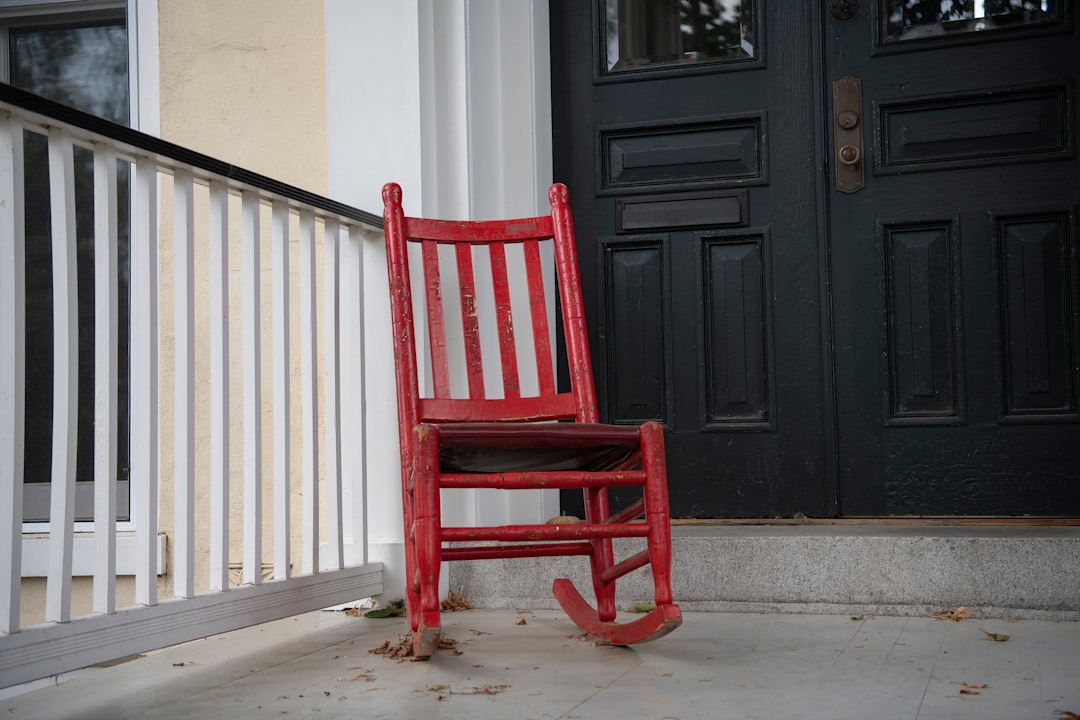 A wooden rocking chair on a front porch