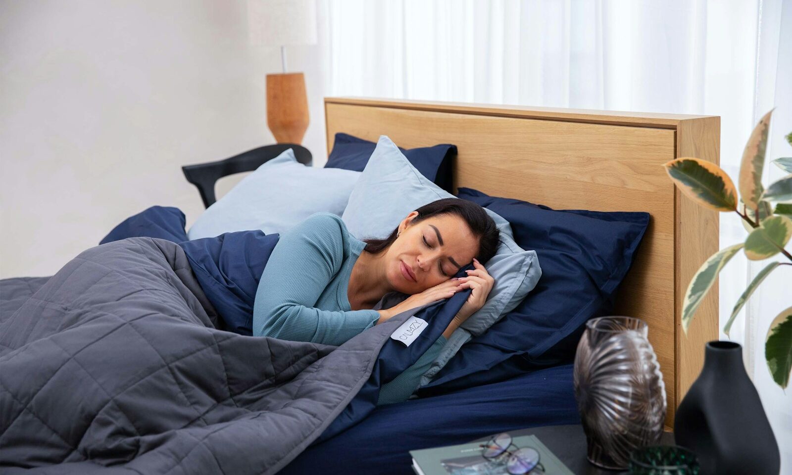 Person using a smartphone in bed, illustrating sleep tracking