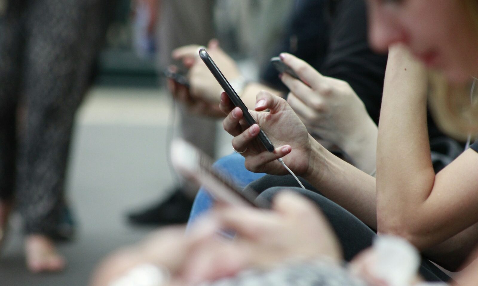 People holding smartphones, illustrating social media use