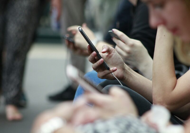 People holding smartphones, illustrating social media use