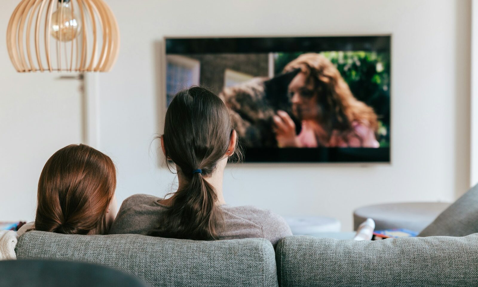 Two people watching television together in a living room