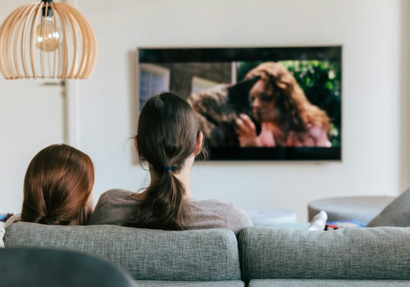 Two people watching television together in a living room