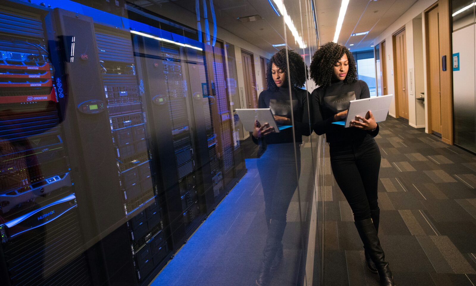 Woman using a laptop in a technology office, illustrating OpenAI’s revenue leadership transition