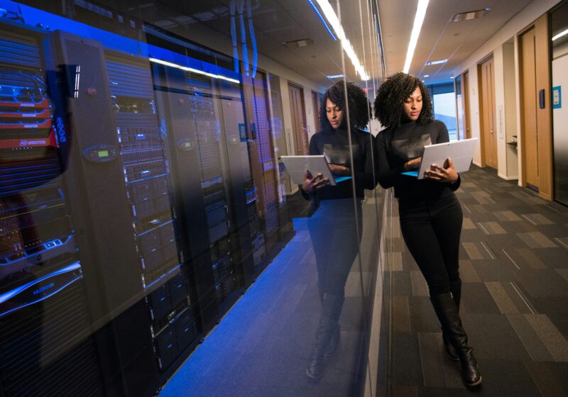 Woman using a laptop in a technology office, illustrating OpenAI’s revenue leadership transition