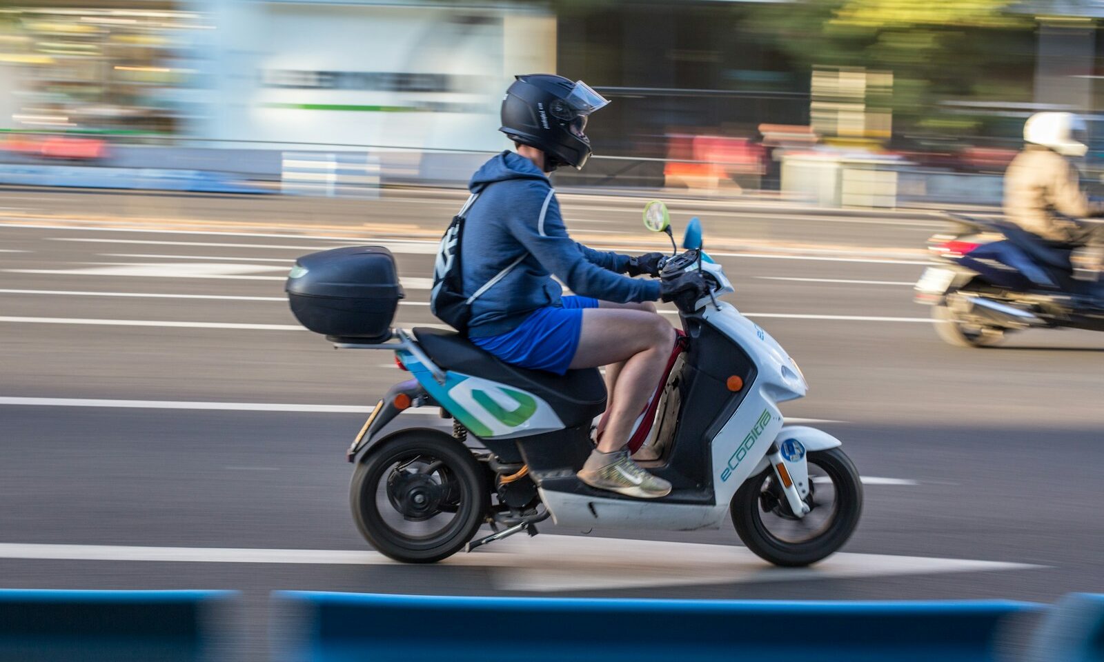 Motorcyclist riding in a city, illustrating electric two-wheeler mobility