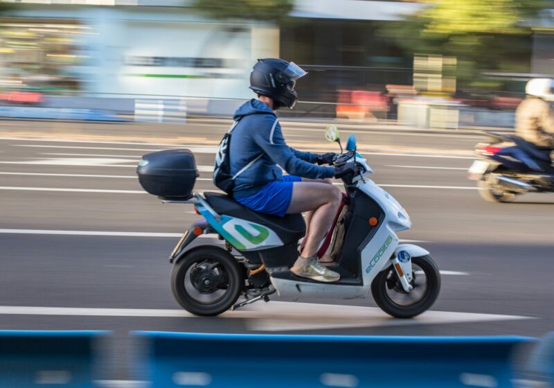 Motorcyclist riding in a city, illustrating electric two-wheeler mobility
