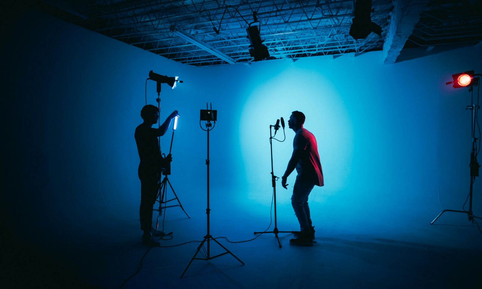 Video creator working in a production studio with cameras and lighting