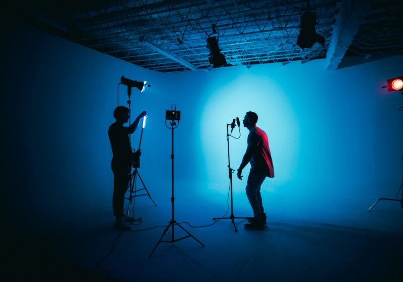 Video creator working in a production studio with cameras and lighting