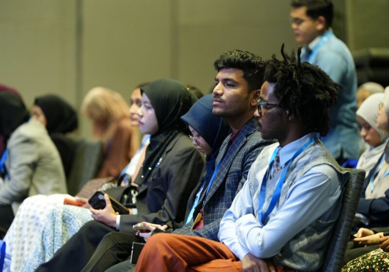 A diverse audience listening at a professional conference.