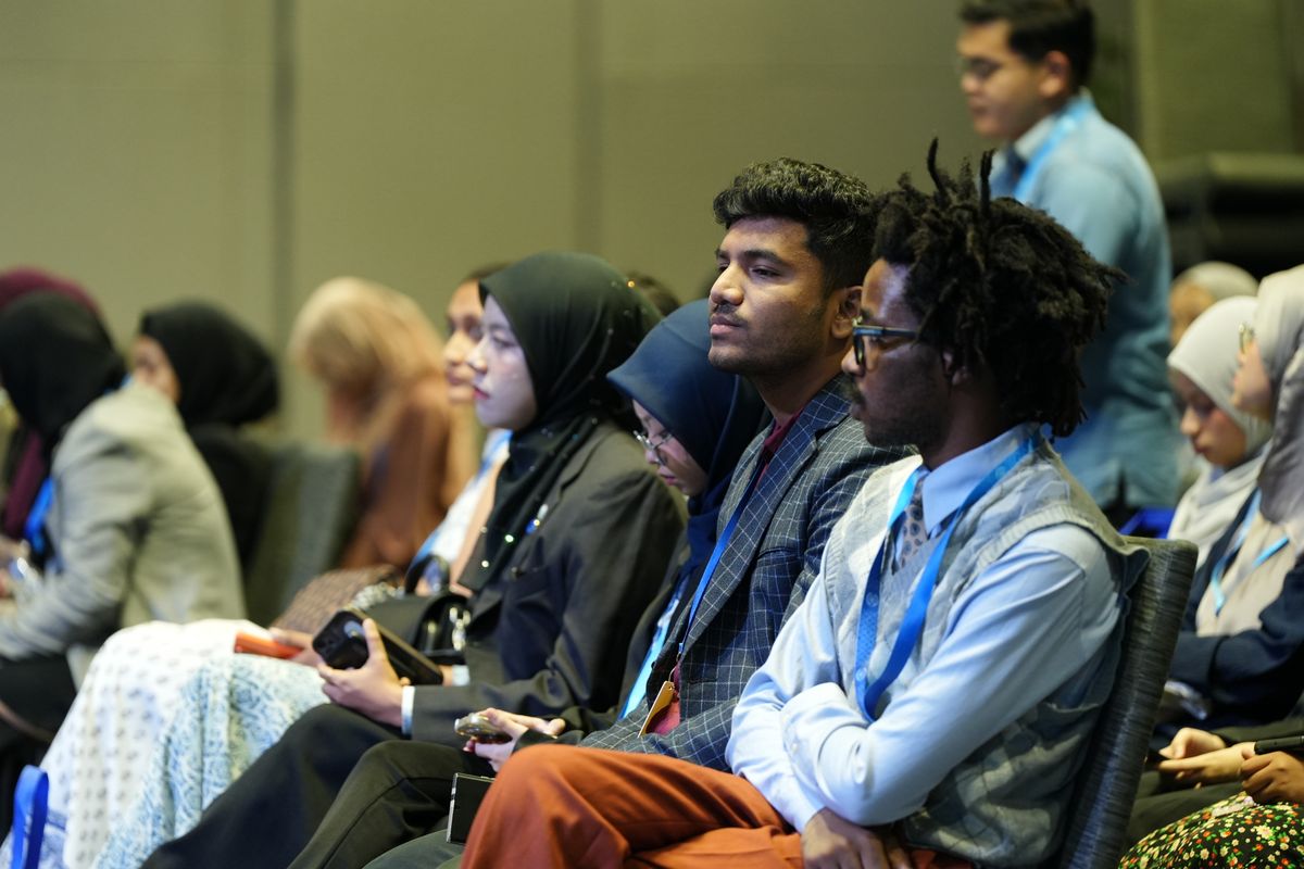 A diverse audience listening at a professional conference.