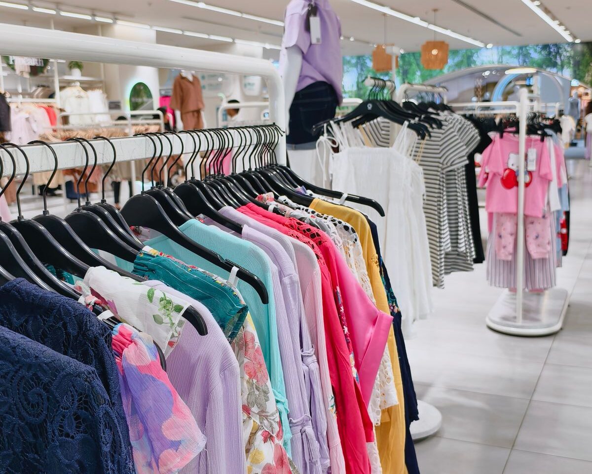 Colorful clothing displayed in a bright modern retail store.