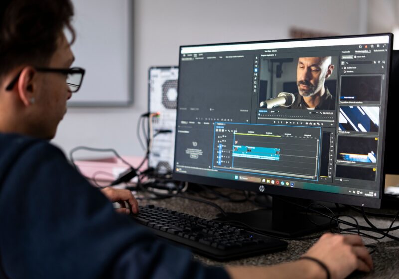 A video editor works at a post-production workstation.