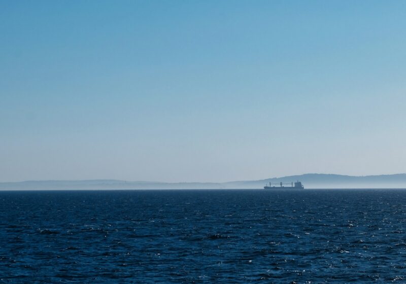 Cargo ship sailing on a clear blue ocean
