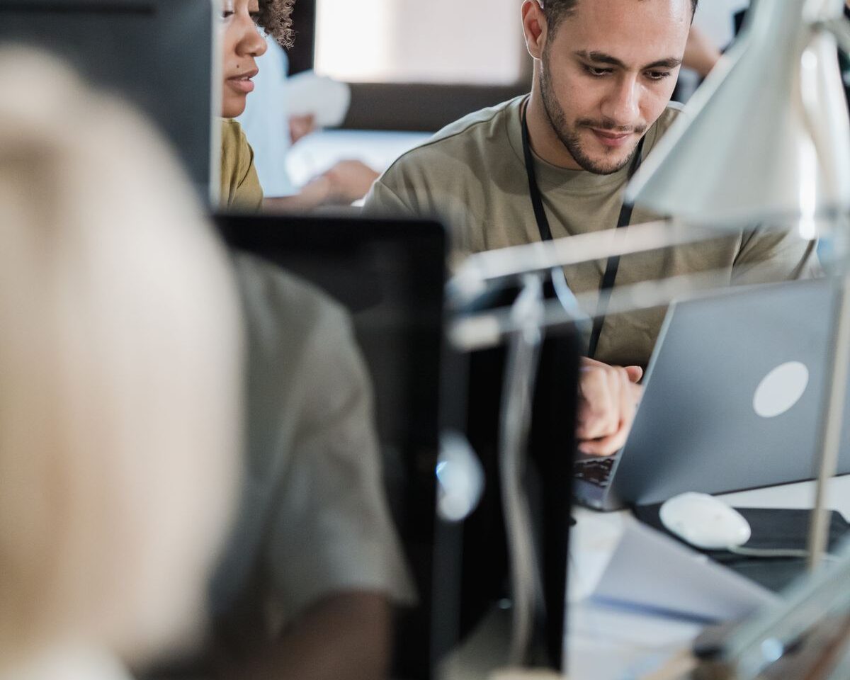Colleagues working at computers in a shared office.