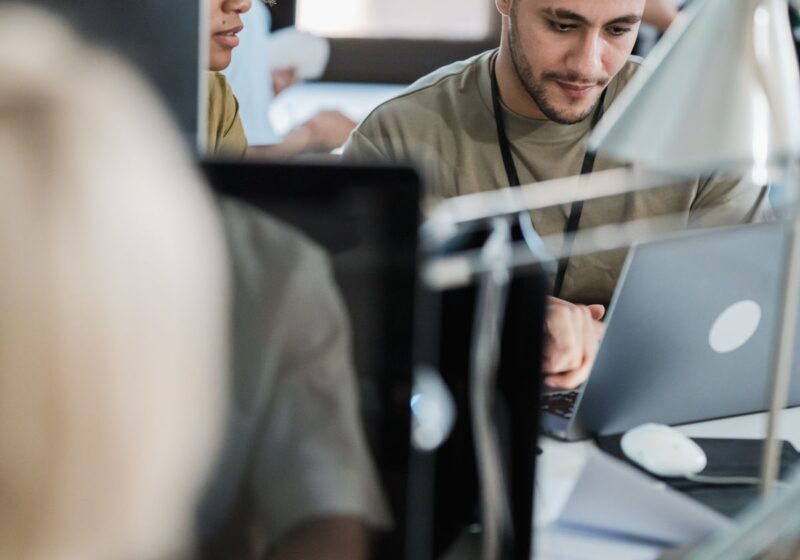 Colleagues working at computers in a shared office.