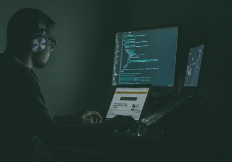 Computer monitors displaying code, illustrating AI model security