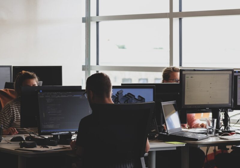 Researchers working at computer monitors, illustrating competition for artificial intelligence talent.