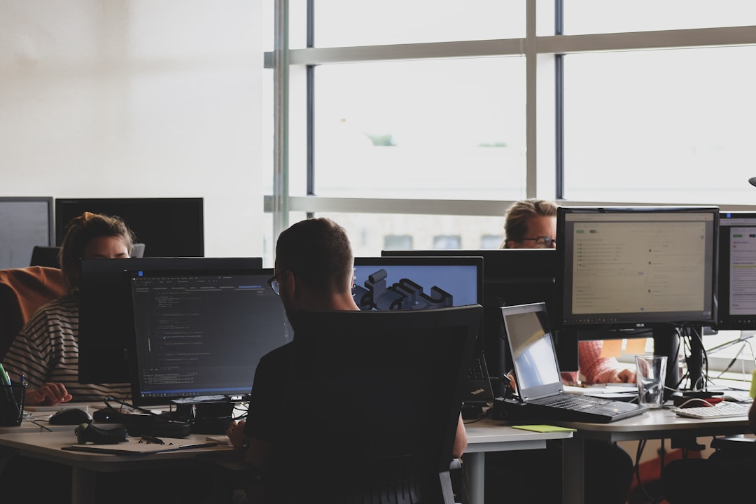 Researchers working at computer monitors, illustrating competition for artificial intelligence talent.