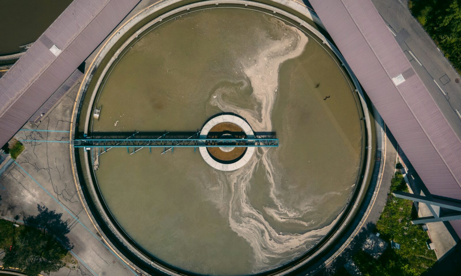 Aerial view of a circular wastewater treatment basin in Zurich, Switzerland; illustrative image, not a U.S. facility in the research.