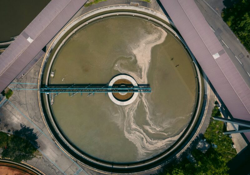 Aerial view of a circular wastewater treatment basin in Zurich, Switzerland; illustrative image, not a U.S. facility in the research.