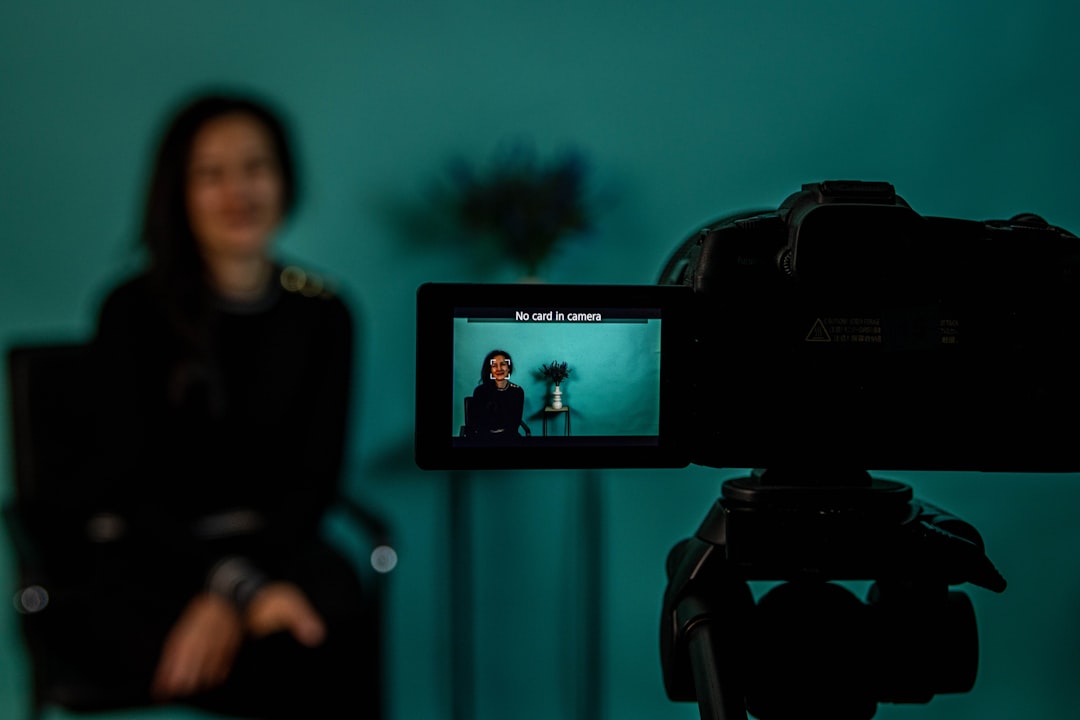 A digital creator filming with a camera, illustrating IMDb's new professional category for online creators.