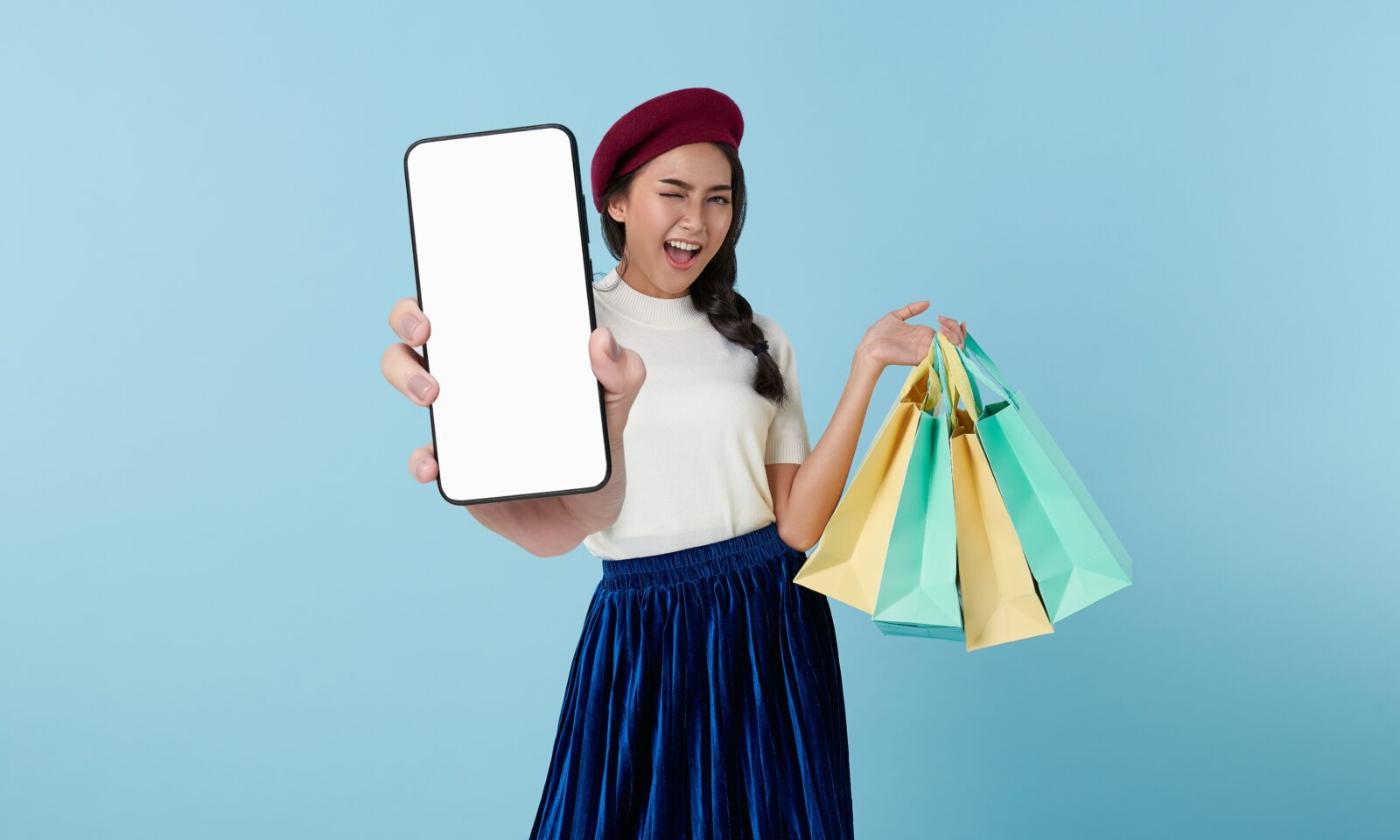 Shopper holding a tablet and shopping bags