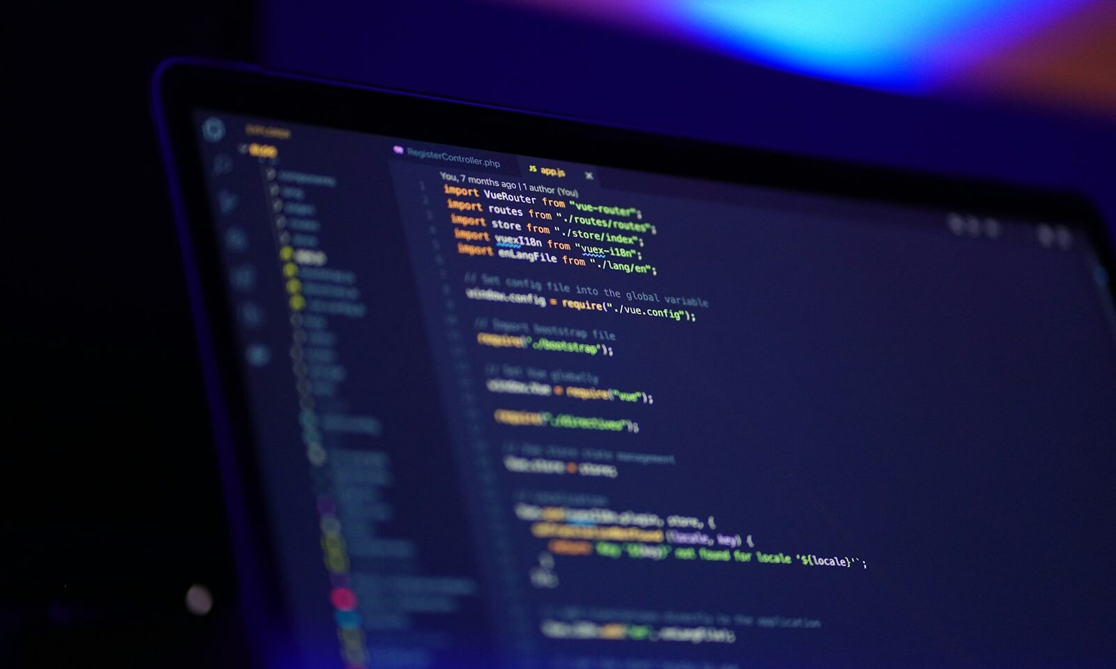Developer working with code on multiple computer screens, illustrating game creation