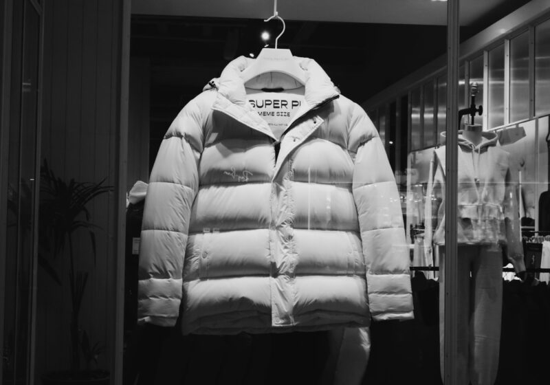 White puffer jacket displayed in a fashion storefront, illustrating Carter’s retail brand strategy