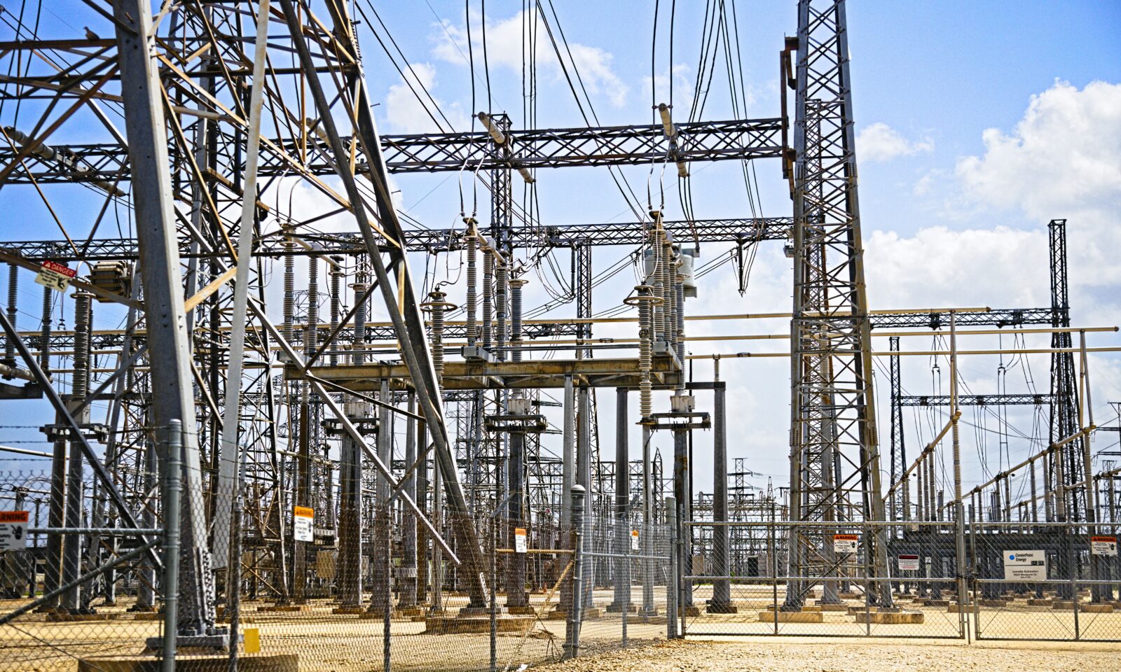 Electrical substation equipment under a blue sky in the Houston area