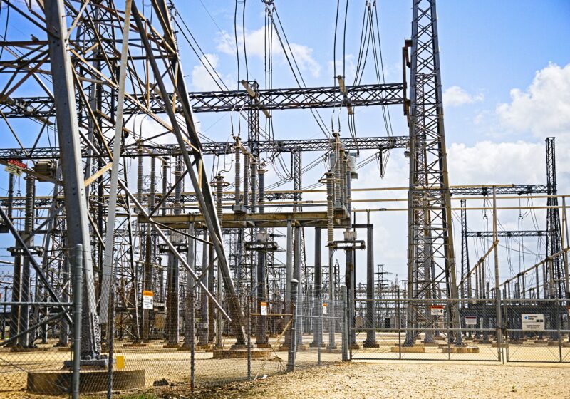 Electrical substation equipment under a blue sky in the Houston area