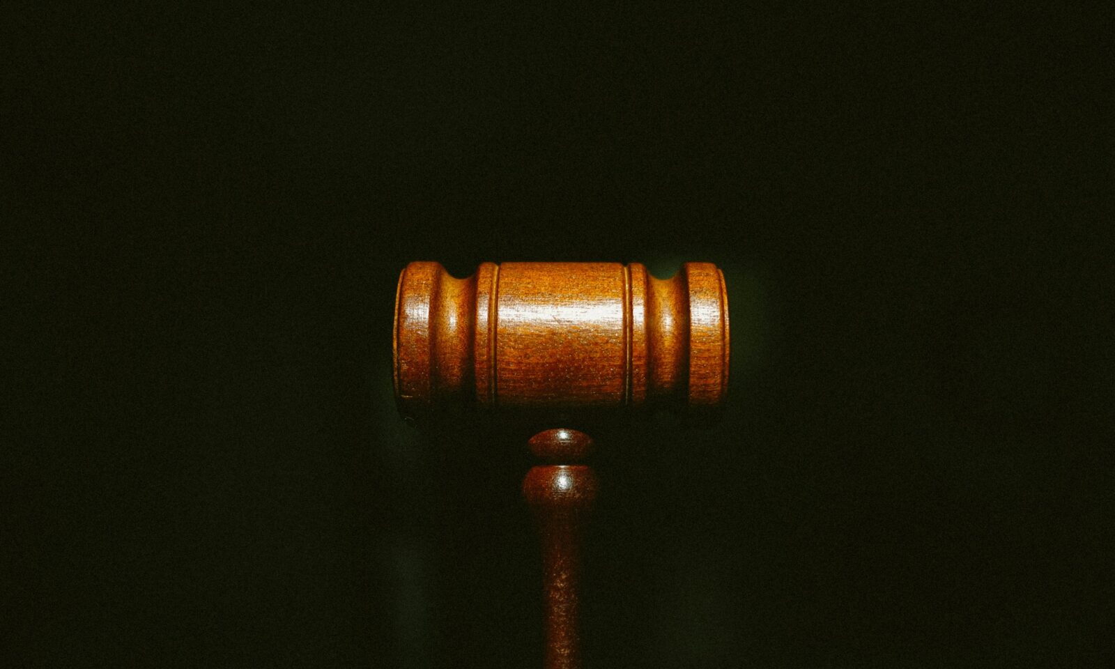 Wooden judge’s gavel on a dark background