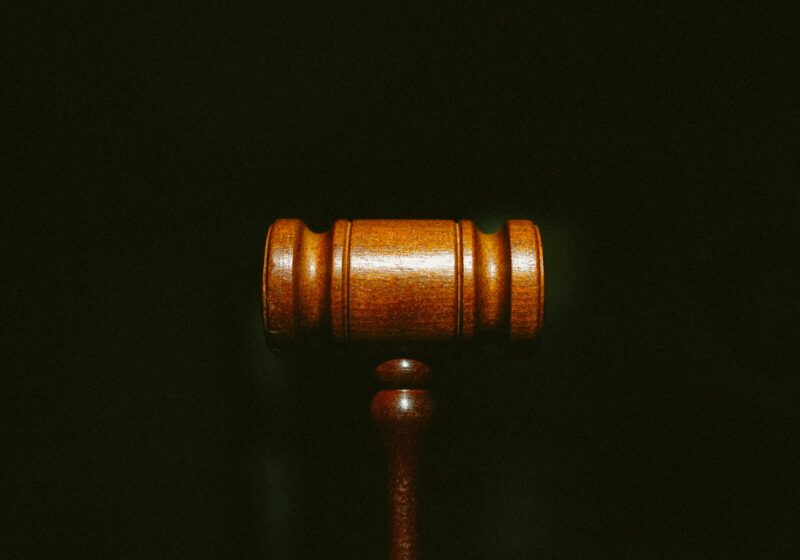 Wooden judge’s gavel on a dark background