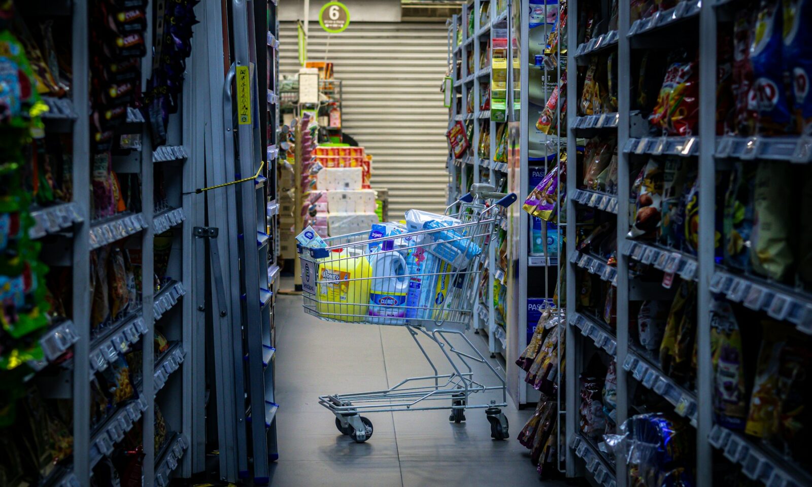 Shopping cart positioned in a grocery store aisle