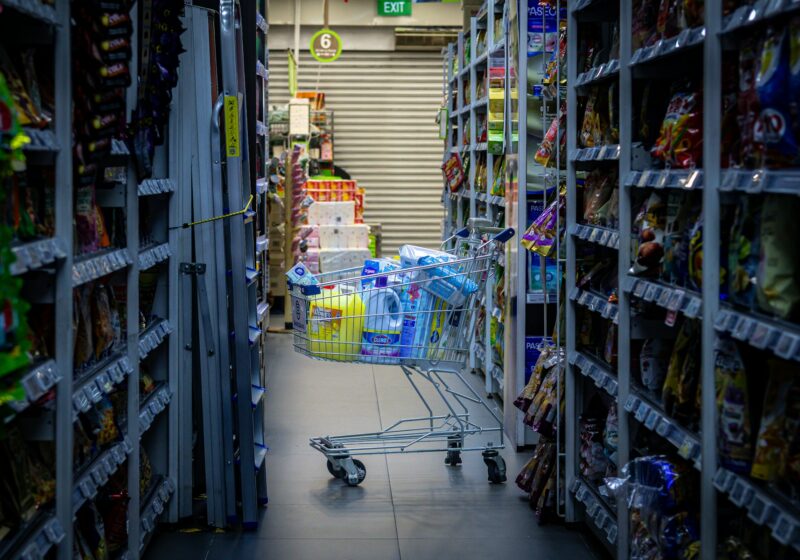 Shopping cart positioned in a grocery store aisle