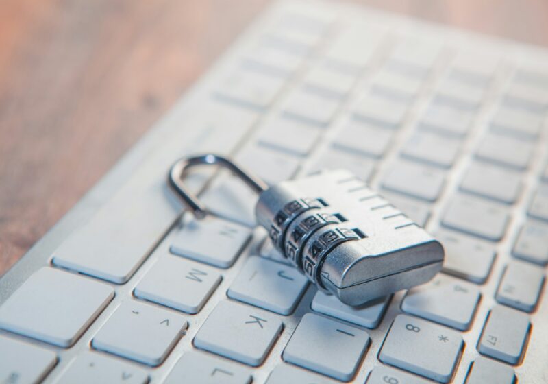 Combination lock resting on a computer keyboard.