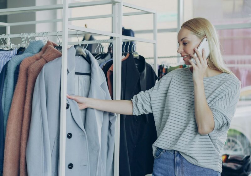 Shopper browsing clothing while using a smartphone